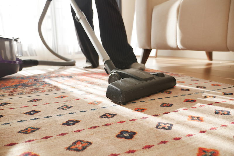 women cleaning with vacuum cleaner